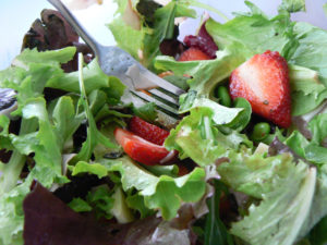 Leafy greens with strawberries