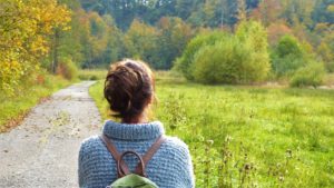 Woman outside looking at a meadow