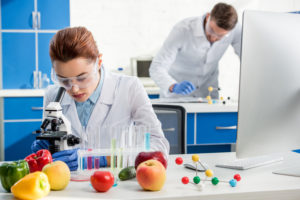 photo of scientist looking through a microscope