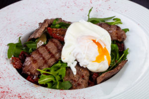 Beef, salad, and a poached egg