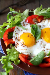 fried eggs with vegetables for breakfast