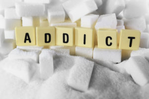 The word ADDICT spelled out in tiles