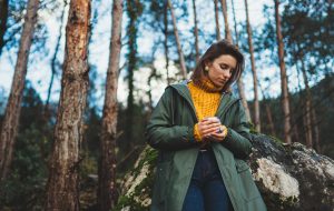 Woman walking in the woods, looking down