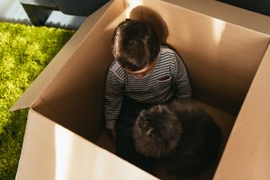 A child in a box with a cat